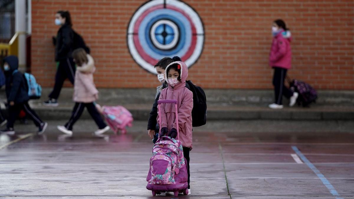 Un grupo de niños esperan para entrar en clase en el inicio de curso escolar después de las vacaciones de Navidad.