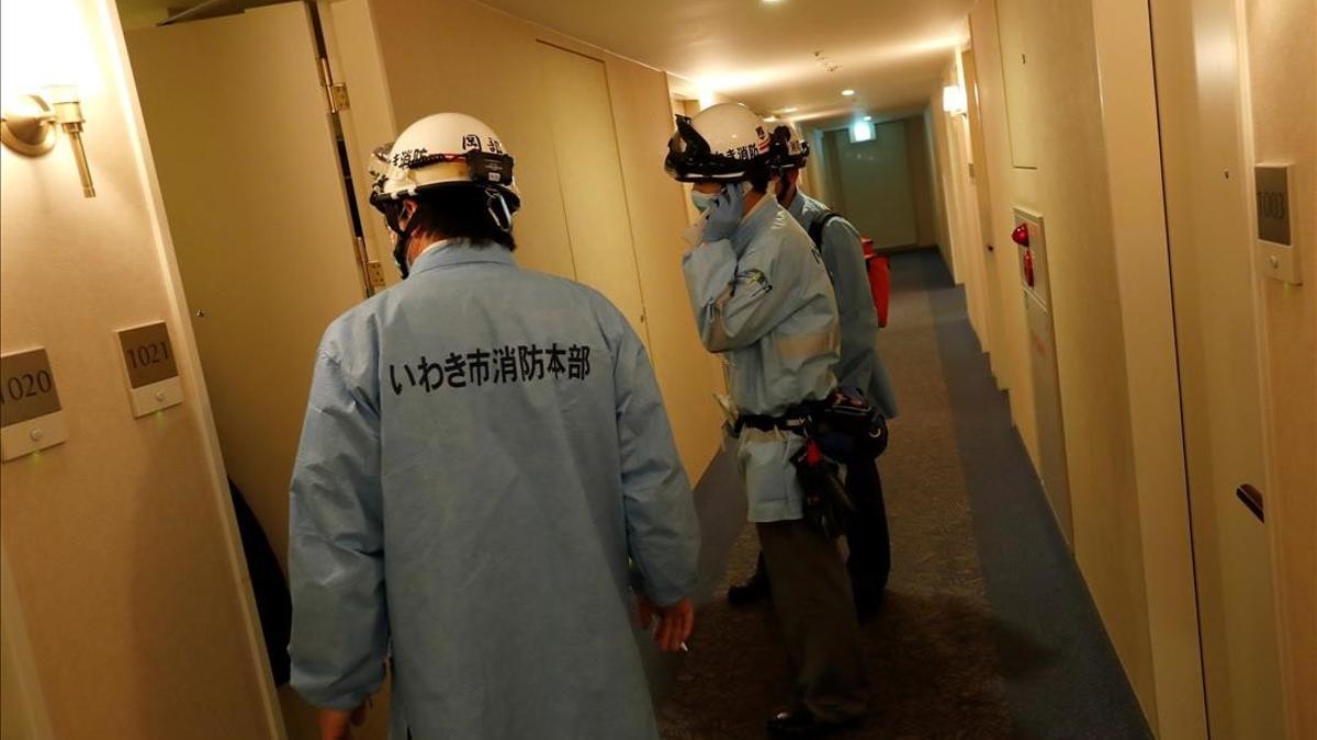 Ambulance crew members stand in the hotel corridor following a strong earthquake in Iwaki  Fukushima prefecture  Japan February 13  2021   REUTERS Issei Kato