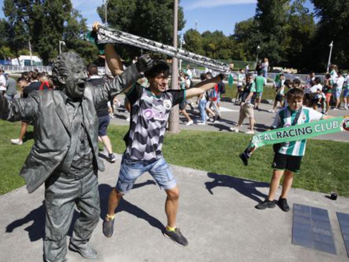 Aficionados rojiblancos con sus bufandas durante el himno del Sporting. | Á. González
