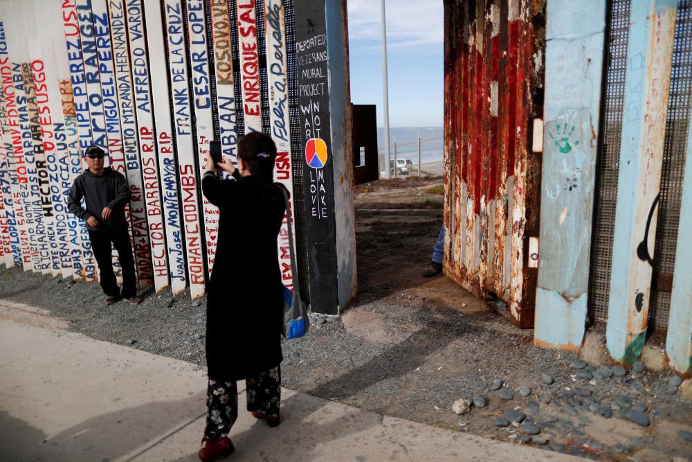 A Chinese tourist poses for pictures next to the ...