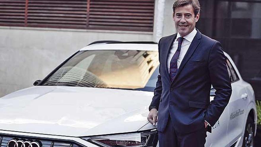 El presidente de Audi EspaÃ±a junto a un coche elÃ©ctrico.