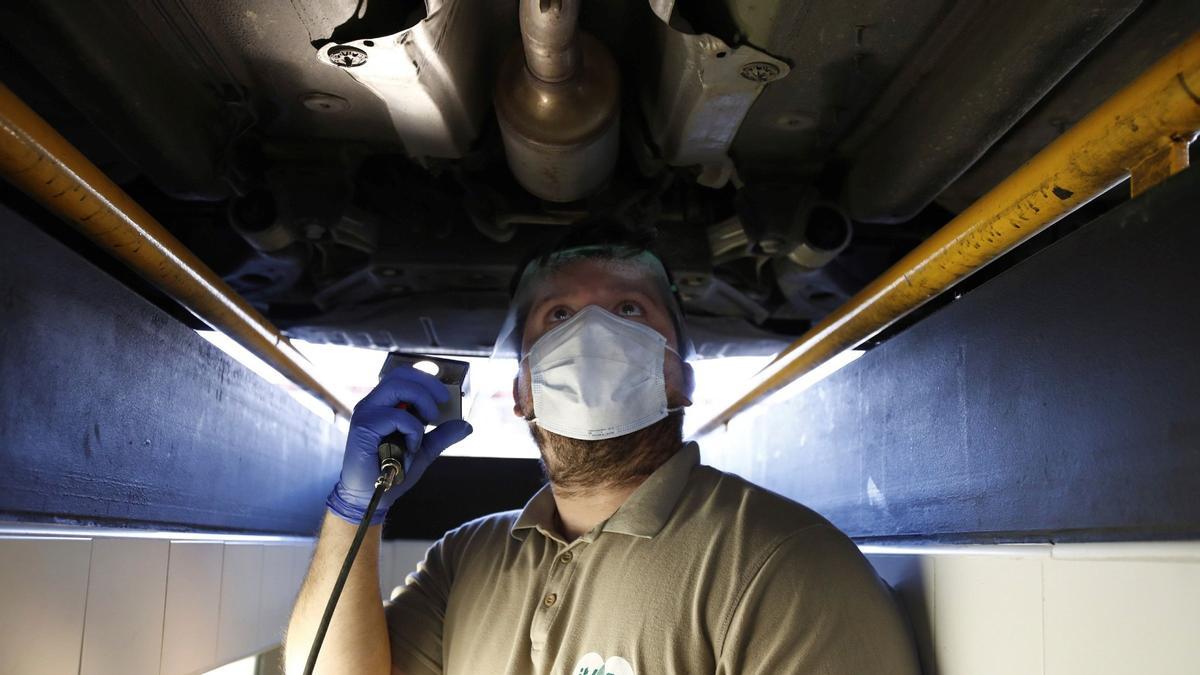 Un operario revisa un coche en un taller de ITV de Madrid, en mayo de 2020