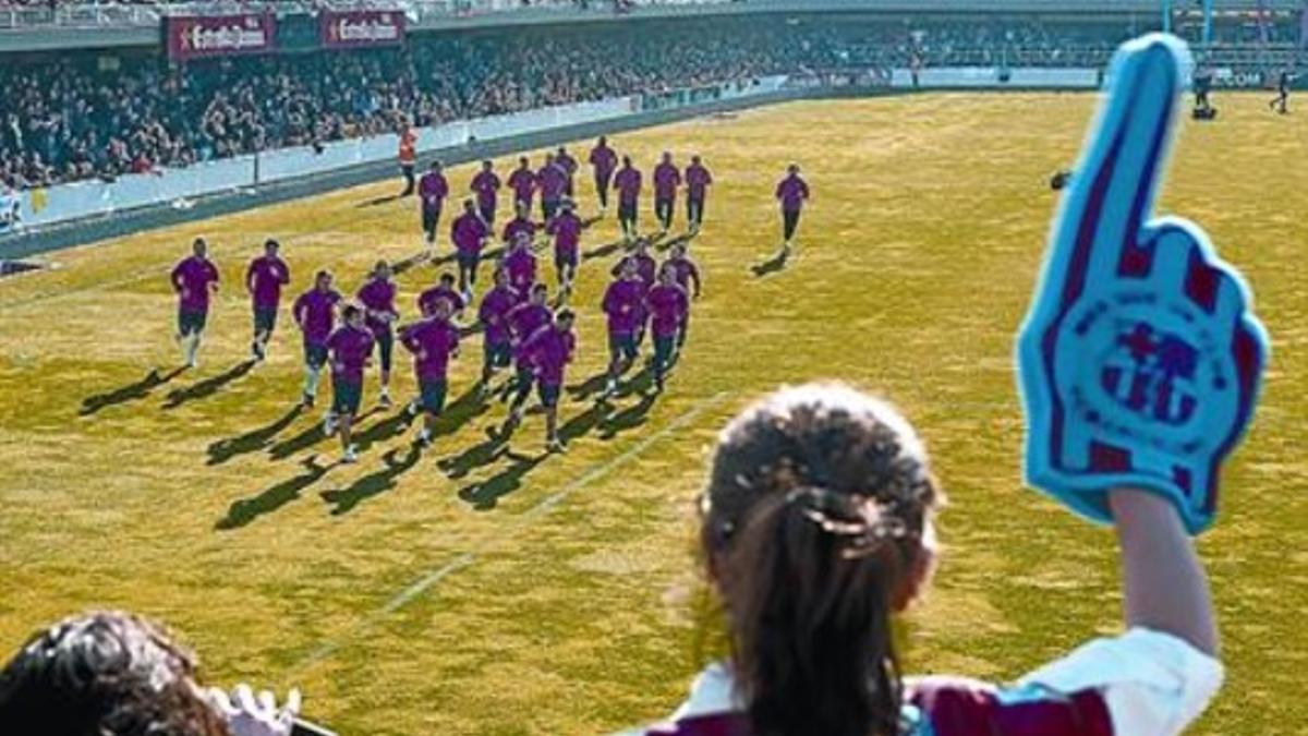 Una niña saluda a los jugadores del Barça, ayer en el Miniestadi.