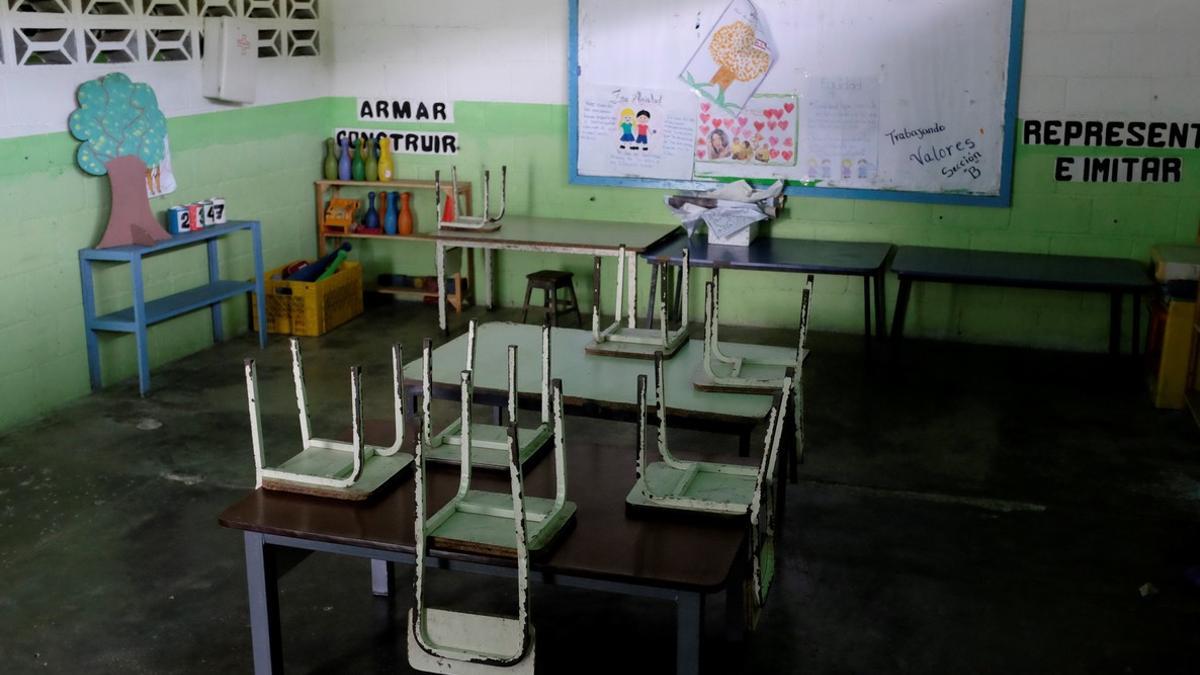 Empty desks are seen in a classroom on the first day of school, in Caucagua