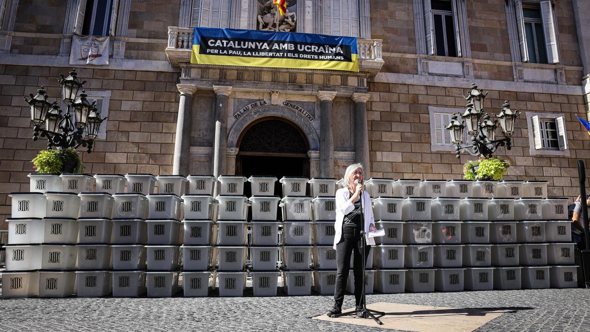 La presidenta de l&#039;ANC, Dolors Feliu, durant l&#039;acció protesta davant del Palau de la Generalitat amb motiu del cinquè aniversari de l&#039;1-O amb el mur d&#039;urnes de fons