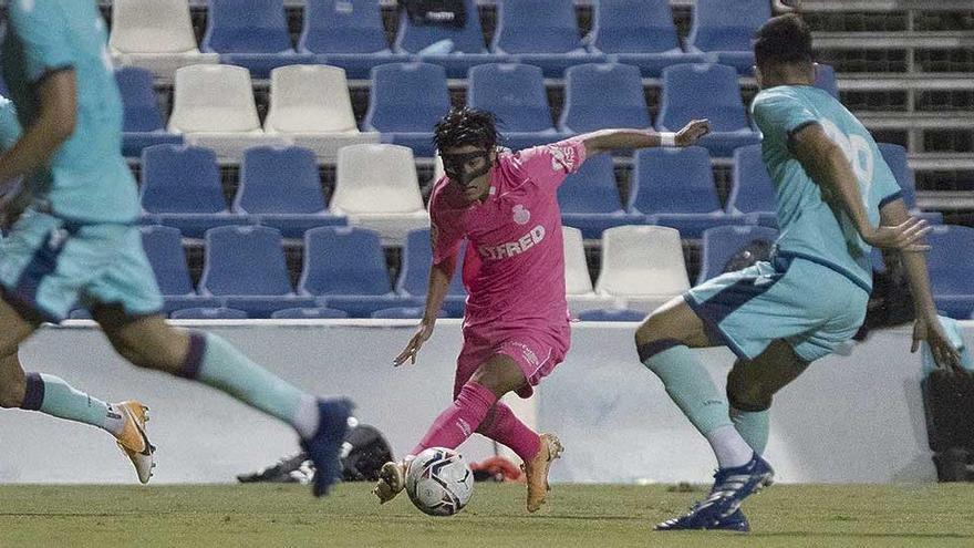 Luka Romero conduce el balón rodeado de jugadores del Levante.