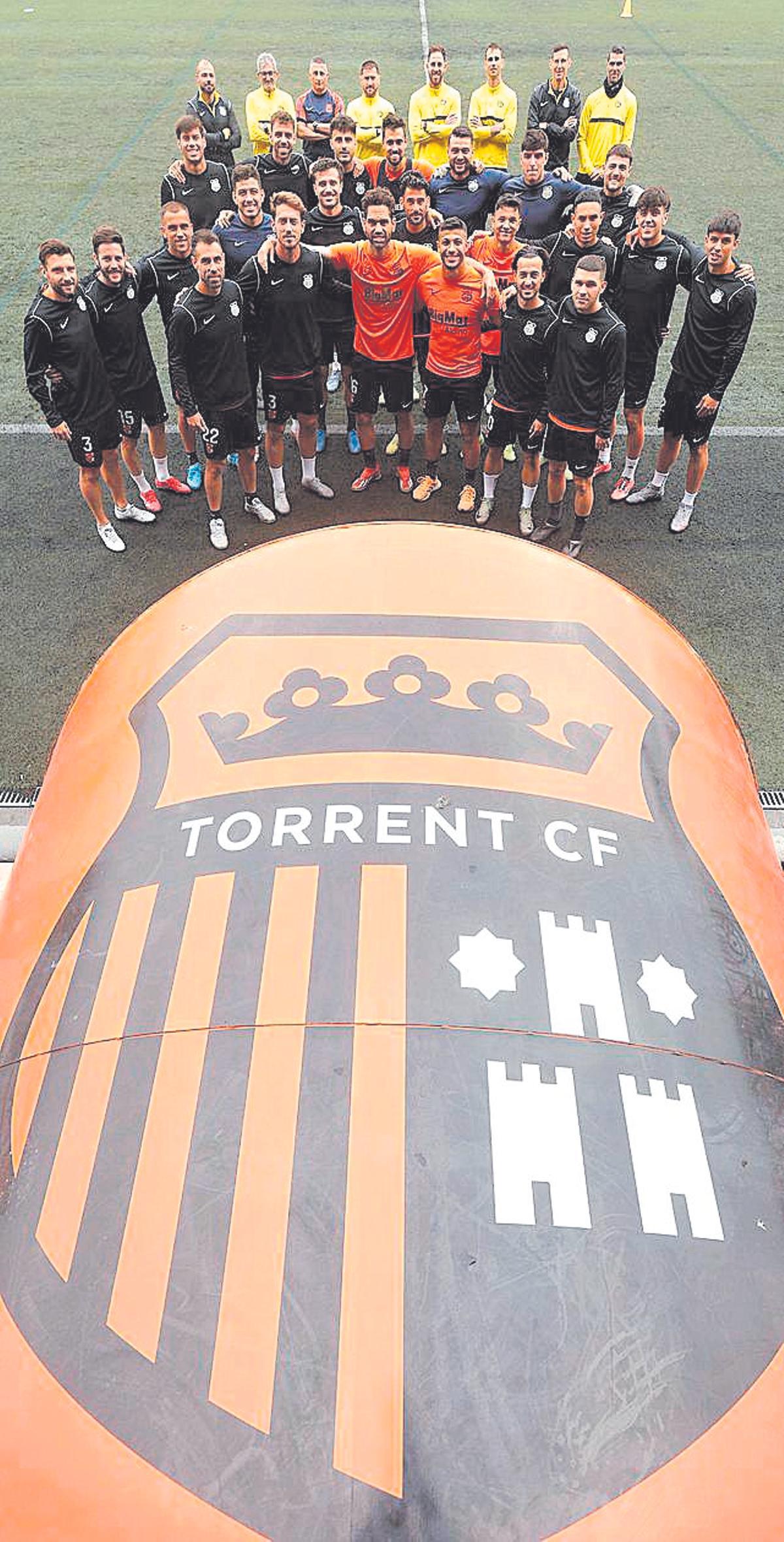 Torrent's team next to the club's shield.