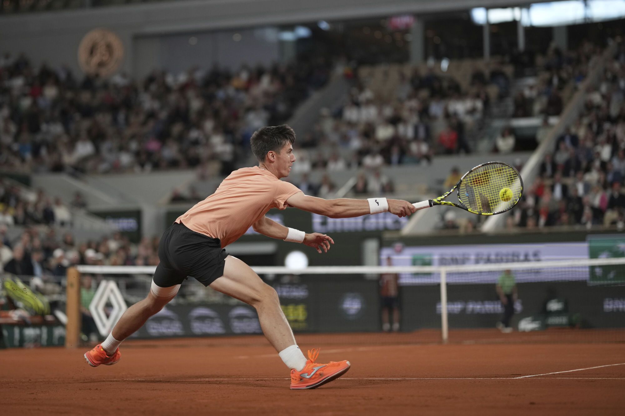 Hungary's Fabian Maroszan returns the ball to Spain's Carlos Alcaraz during their second round match of the French Tennis Open, at the Roland-Garros stadium, in Paris, Wednesday, May 28, 2025. (AP Photo/Christophe Ena)