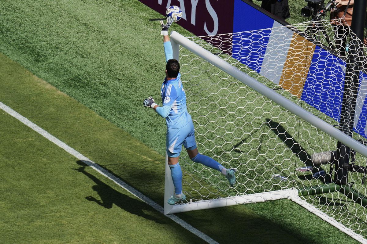 Real Madrid's Thibaut Courtois (1) makes a leaping save on a shot by Paris Saint-Germain during the Club World Cup semifinal soccer match between PSG and Real Madrid in East Rutherford, N.J., Wednesday, July 9, 2025. (AP Photo/Pamela Smith)