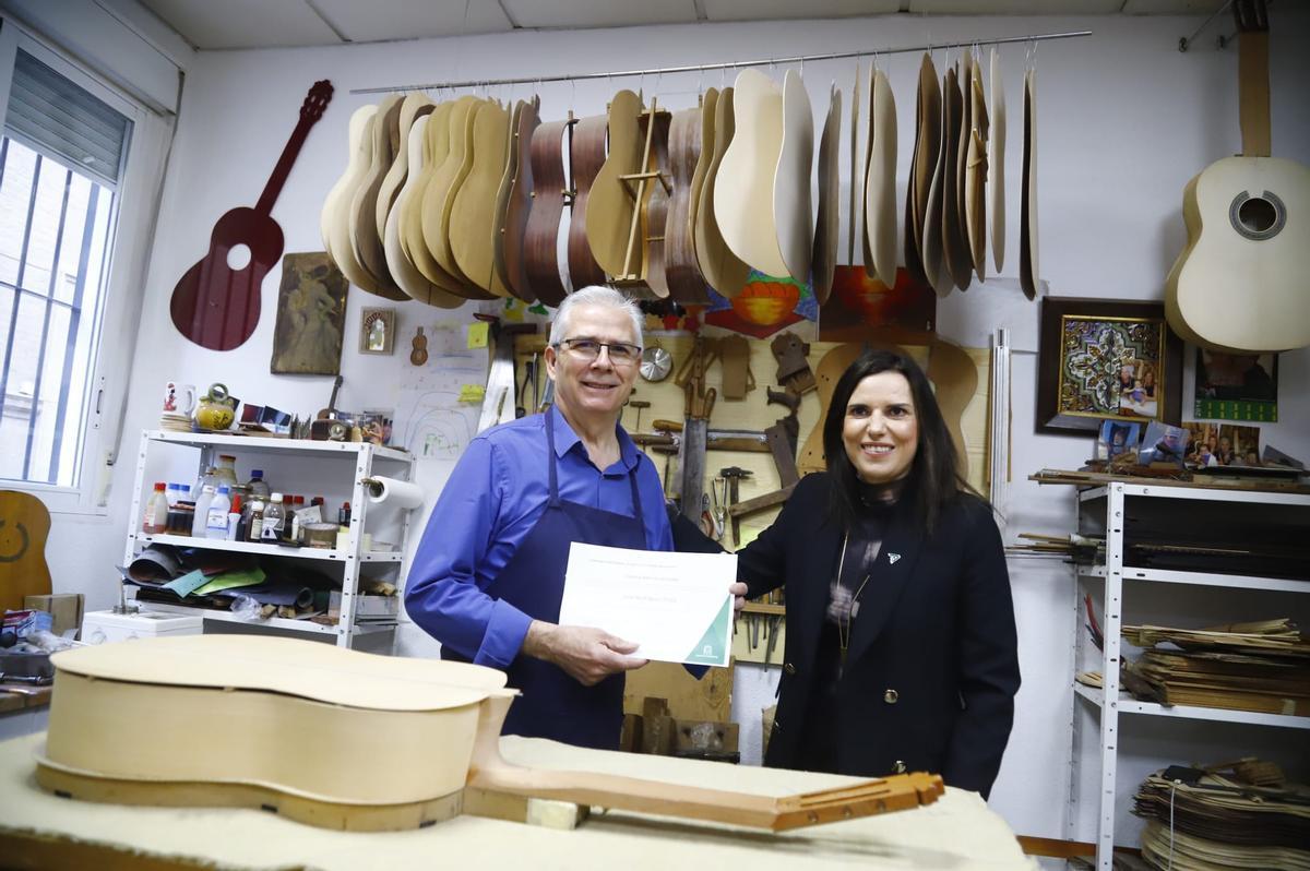 El luthier José Rodríguez Peña y la delegada de Empleo, Mª Dolores Gálvez, en la entrega de la carta de maestro artesano de la Junta.