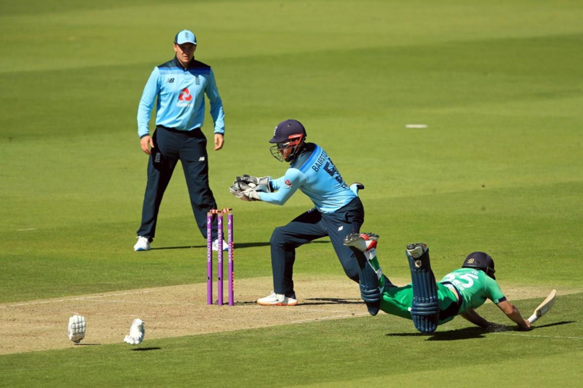 El irlandés Andy McBrine (R) se lanza al suelo, para un intento de punto, durante el primer partido internacional de un día de cricket entre Inglaterra e Irlanda en el Ageas Bowl en Southampton.