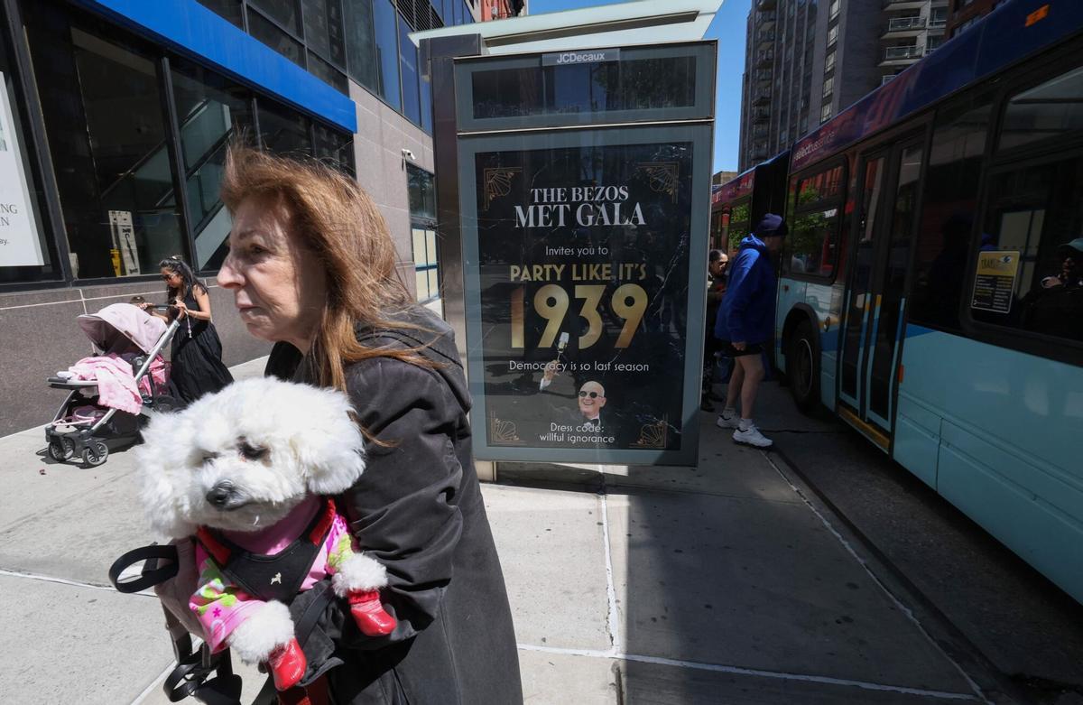 A "Boycott The Bezos Met Gala" poster hangs on a bus stop in the Manhattan borough of New York City on April 27, 2026. Amazon’s Jeff Bezos and Lauren Sanchez are the lead sponsors and honorary co-chairs of the 2026 Met Gala, taking place on May 4th. (Photo by TIMOTHY A. CLARY / AFP)