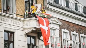 Vecinos de Copenhague siguen la etapa del Tour desde un balcón de la ciudad.