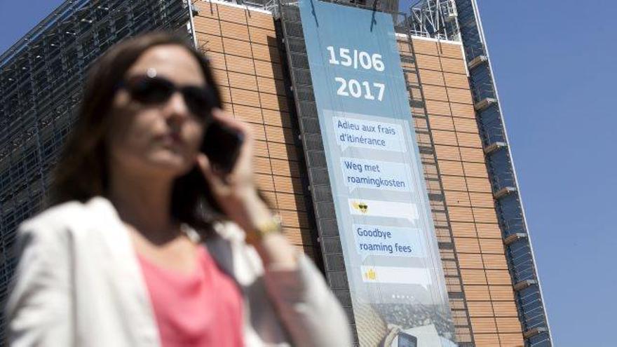 Una dona truca per telèfon davant d&#039;un anunci sobre la fi del &#039;roaming&#039;