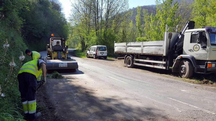 Dos operarios trabajan en la carretera de Tarna, en las inmediaciones de Campo de Caso.