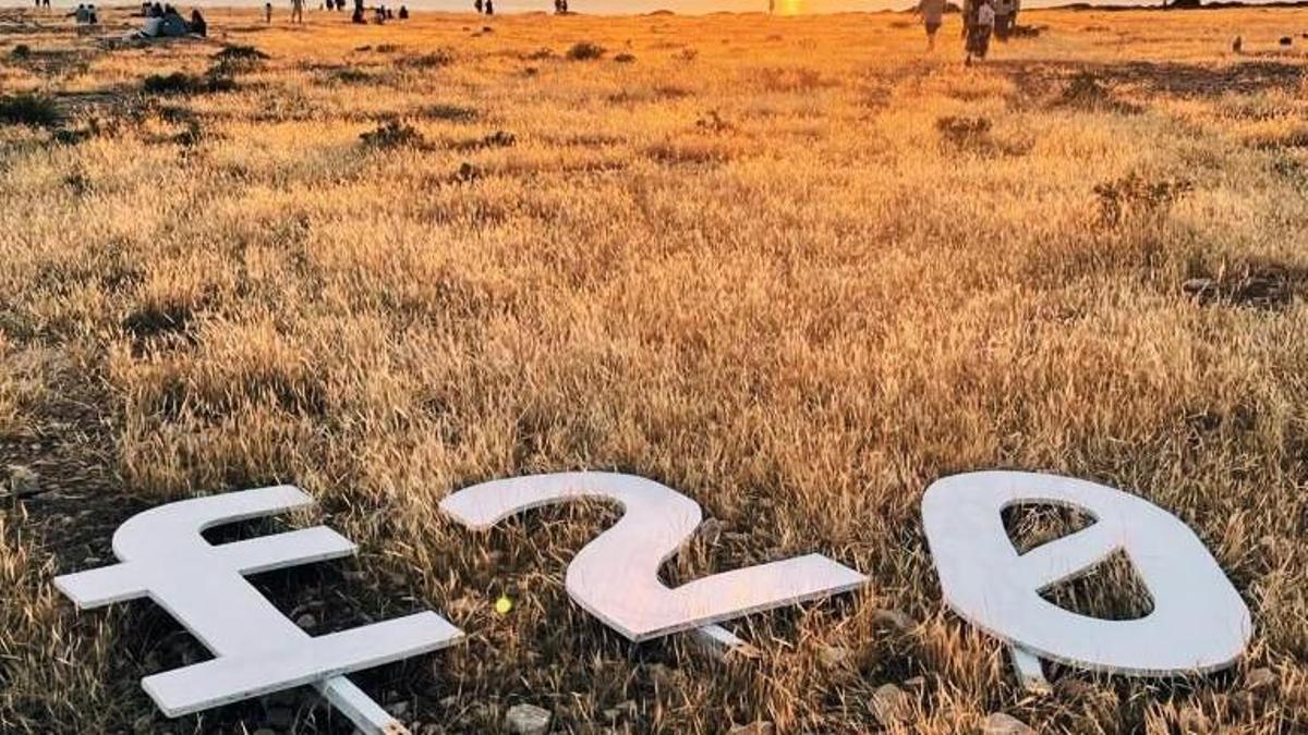 El logotipo de Formentera20 durante una puesta de sol en el faro de es Cap de Barbaria