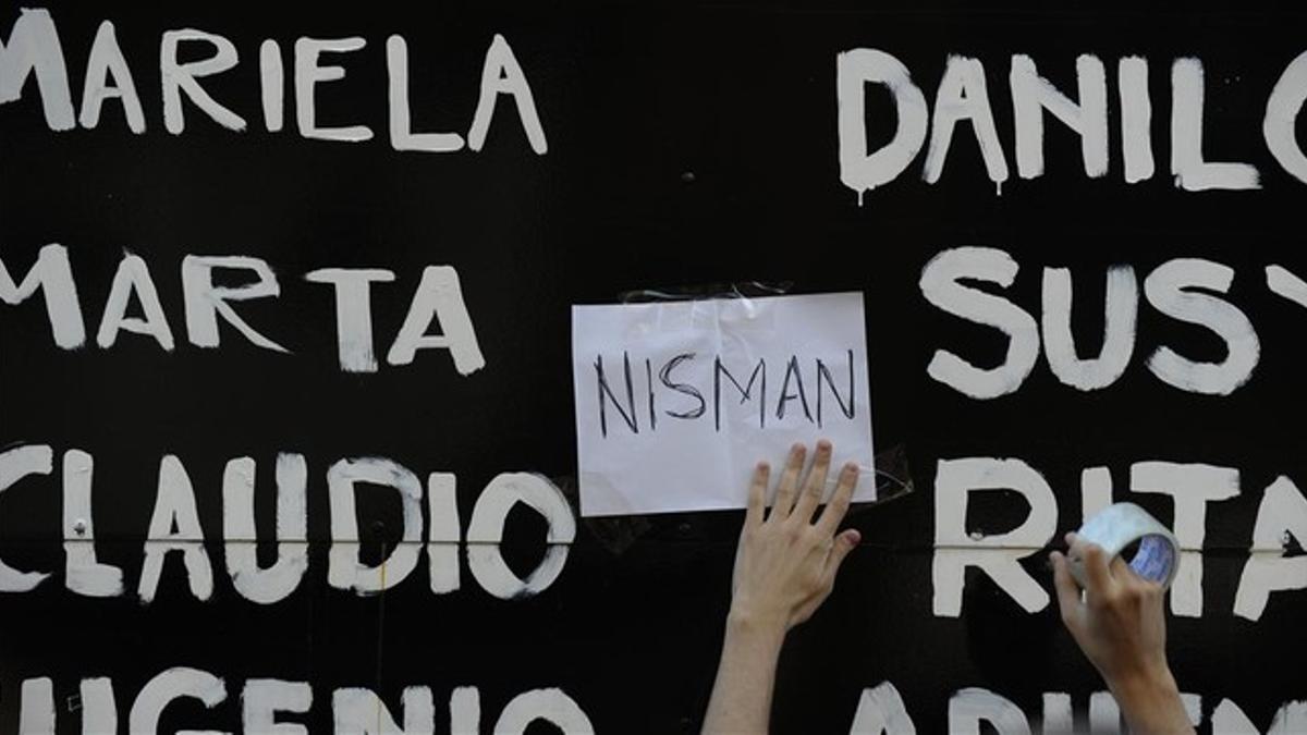 rmassaguea man places a sign that reads  nisman  amid the n150123164701