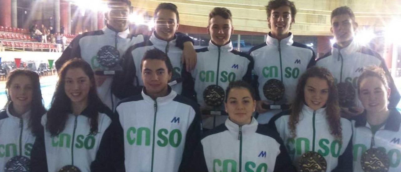 Los nadadores muestran los trofeos logrados en la competición.