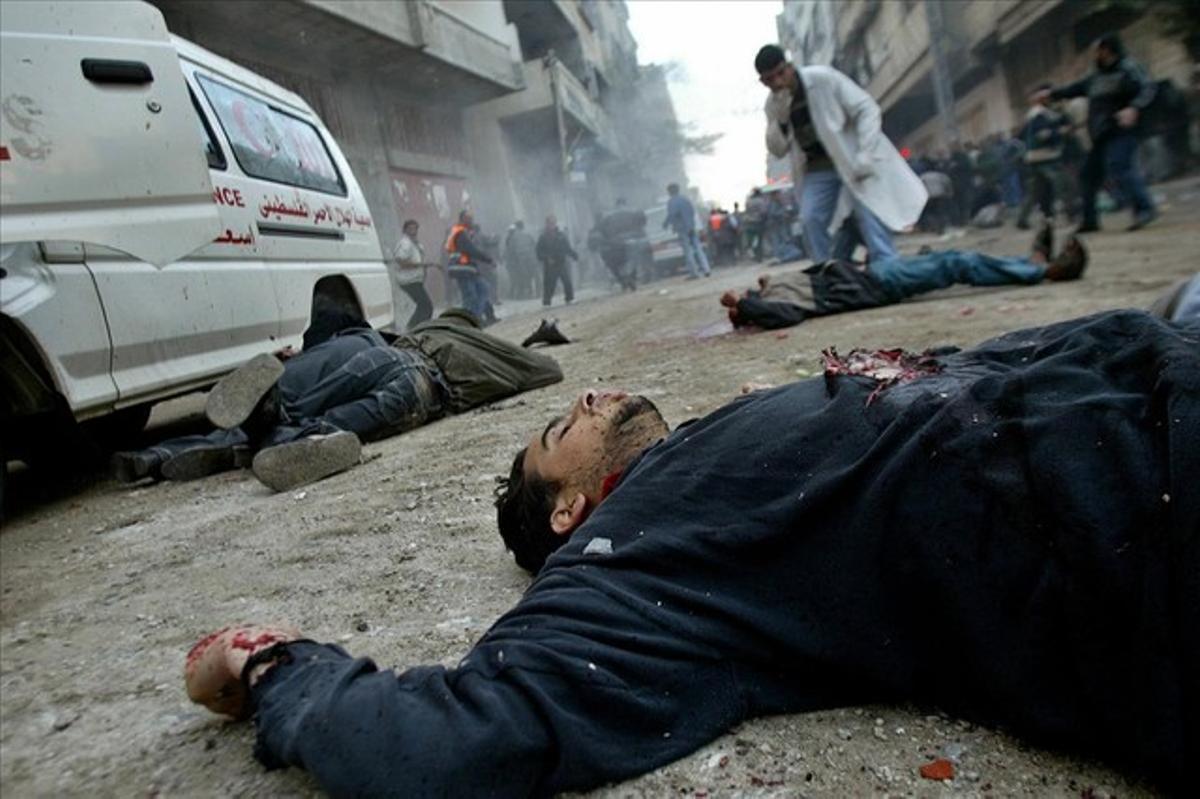 Unidentified bodies lie on a street in the Jabalya refugee camp in northern Gaza Strip early in this March 6, 2003 file photo.
