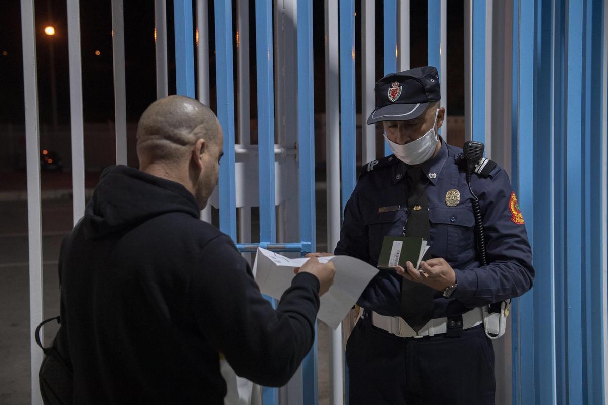 Ceuta (Spain), 17/05/2022.- A man is stopped and checked by authorities at a border crossing while leaving the Moroccan city of Fnidef, as seen from Ceuta, Spanish enclave in northern Africa, 17 May 2022. The border between Ceuta and Melilla and northern Africa were opened at midnight on Tuesday after a 26-month closure. (Marruecos, España) EFE/EPA/Jalal Morchidi