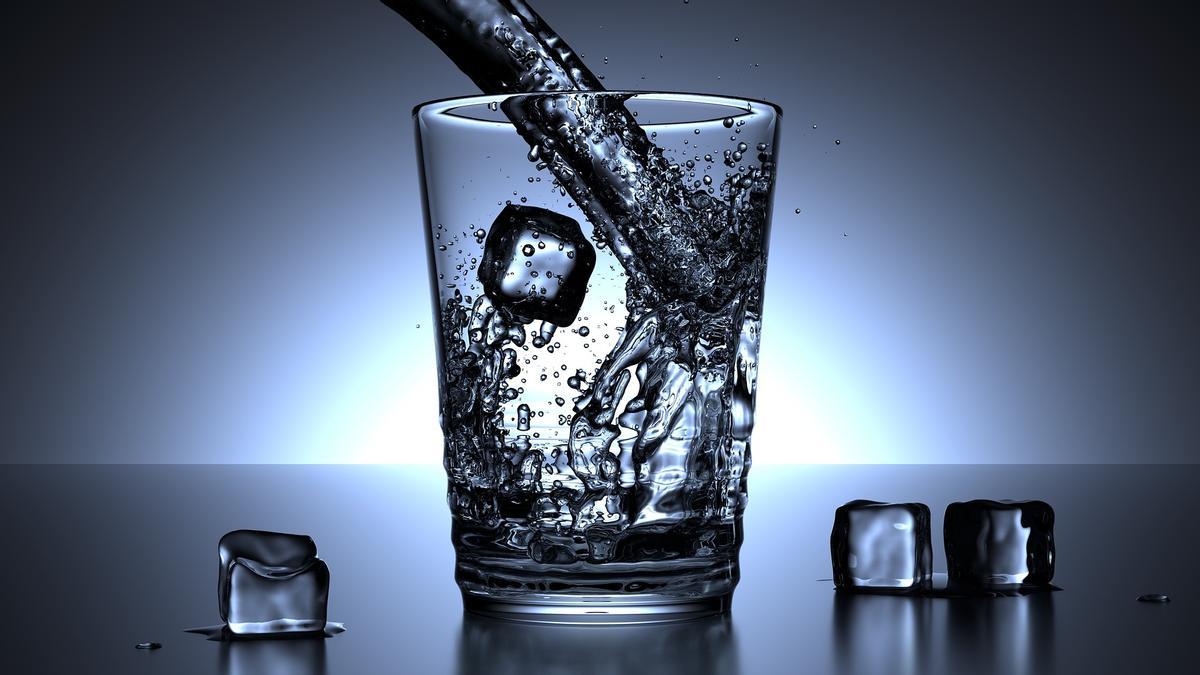 Vaso de agua con cubos de hielo.