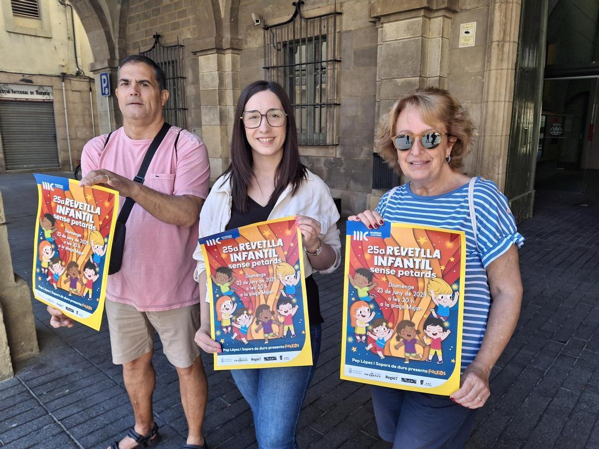 La regidora de Cultura, Tània Infante Martínez, al mig, i representants d’Imagina’t, Joan Vilà Ascón i Fina González Valls, mostren el cartell de la 25a Revetlla infantil sense petards