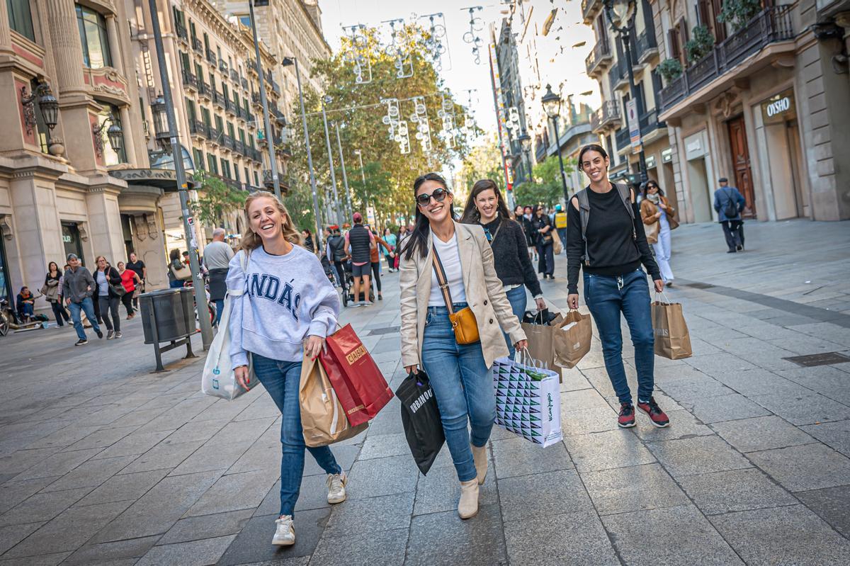 Un grupo de jóvenes con bolsas después de ir de compras en Barcelona.