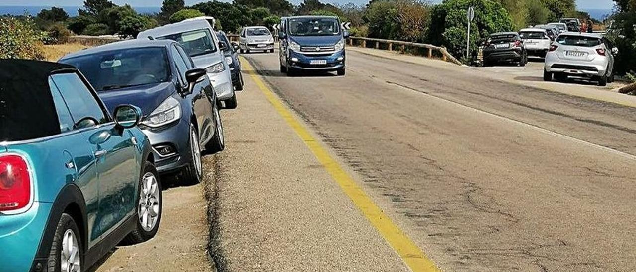 Vehículos mal estacionados en el acceso a Cala Varques.