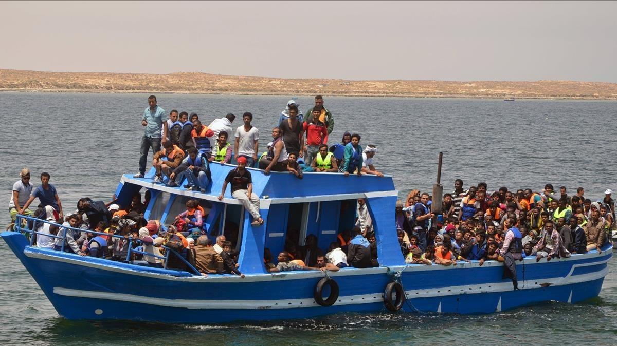 undefined29998084 illegal migrants are seen on a boat after being rescued by t180114182723