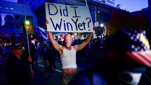 A Trump supporter wears a mask of U.S. Democratic presidential nominee Joe Biden and carries a sign during a protest outside of the Philadelphia Convention Center, where votes are still being counted two days after the 2020 U.S. presidential election, in Philadelphia, Pennsylvania, U.S. November 5, 2020.  REUTERS/Mark Makela