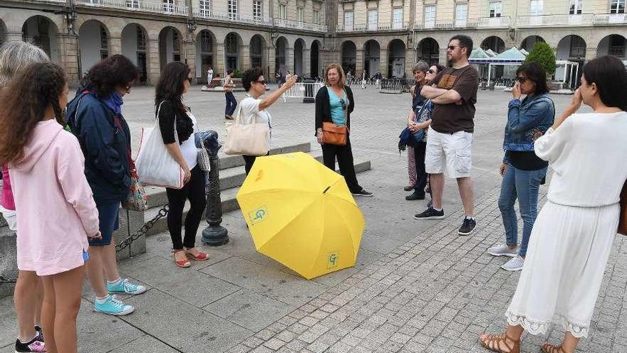 Una guía turística autorizada muestra la plaza de María Pita a viajeros.