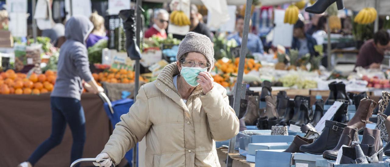 Una mujer con mascarilla en el mercadillo de Teulada en los días previos al estado de alarma