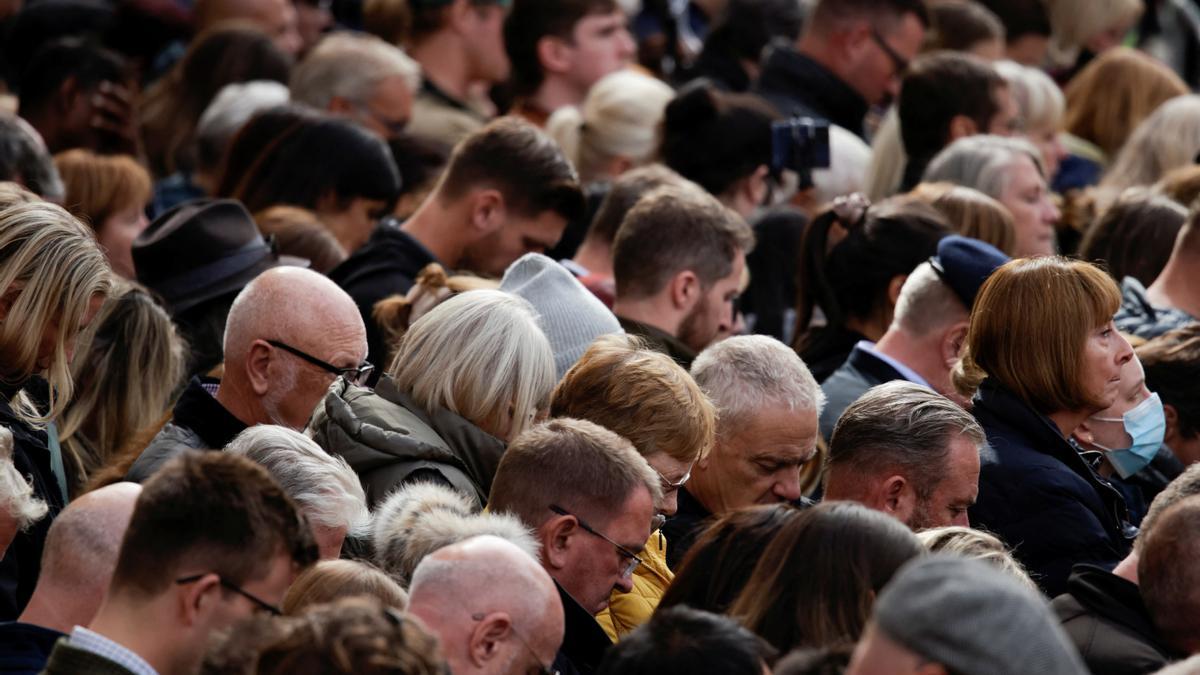 Ciudadanos guardan dos minutos de silencio en memoria de la reina Isabel II, durante los actos de su funeral de estado