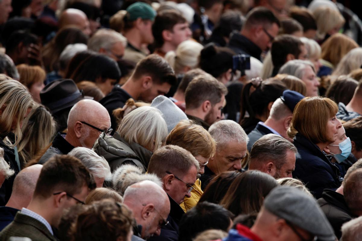 Ciudadanos guardan dos minutos de silencio en memoria de la reina Isabel II, durante los actos de su funeral de estado.