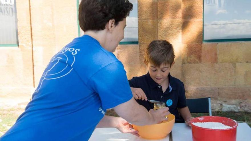 La monitora Ángeles Rodríguez, en el momento de la preparación de la plastilina, ante Miguel García.