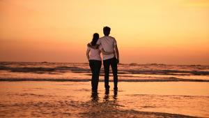Pareja viendo el atardecer en la playa