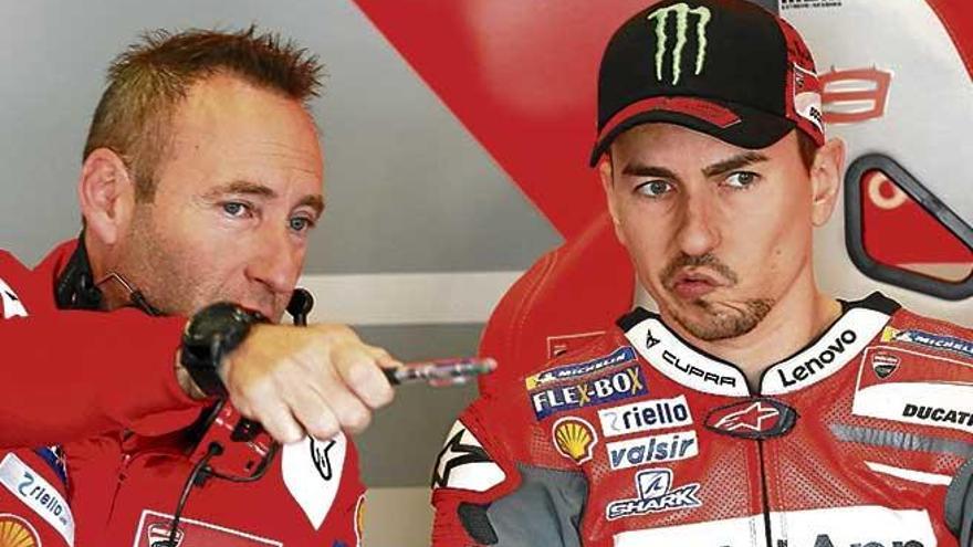 Jorge Lorenzo atiende ayer a uno de los técnicos de su equipo en el box de Ducati.