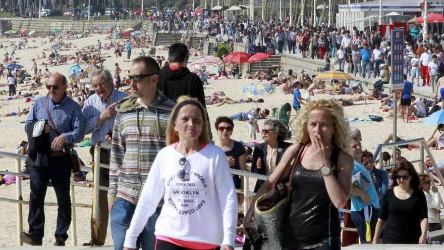 Paseantes y bañistas ayer por la tarde en la playa viguesa de Samil.  // Jose Lores