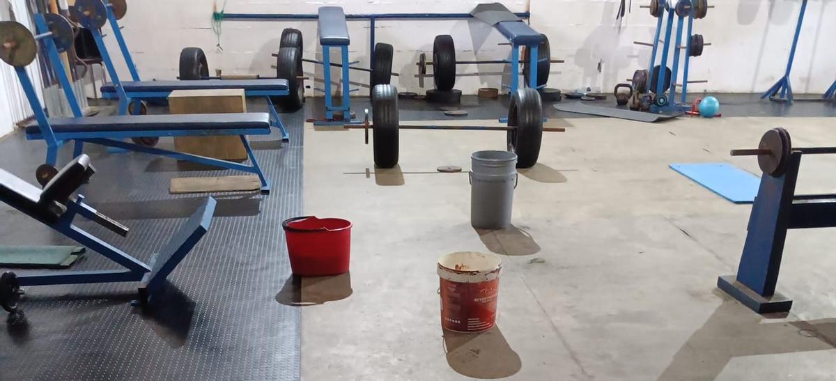 El gimnasio, ayer, con cubos para paliar los efectos de las goteras.