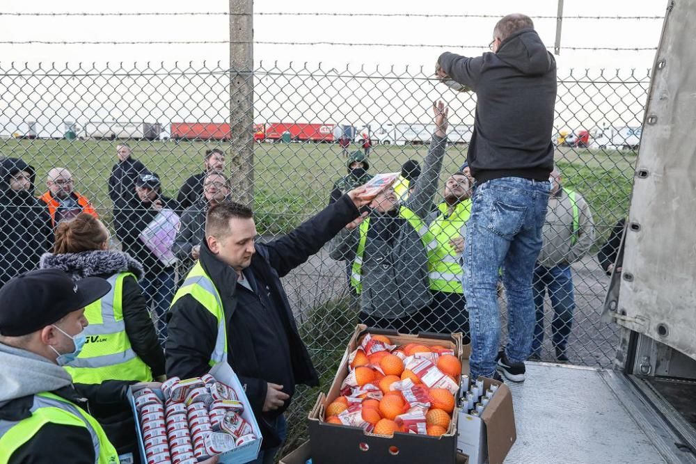 Reparten víveres a los camioneros confinados en un aeropuerto