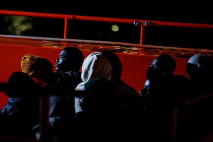 Migrants wait to disembark from a Spanish coast ...