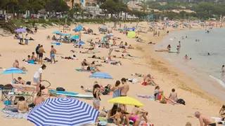 Desallotgen part d'una platja de Sant Feliu per un vessament d'aigües residuals