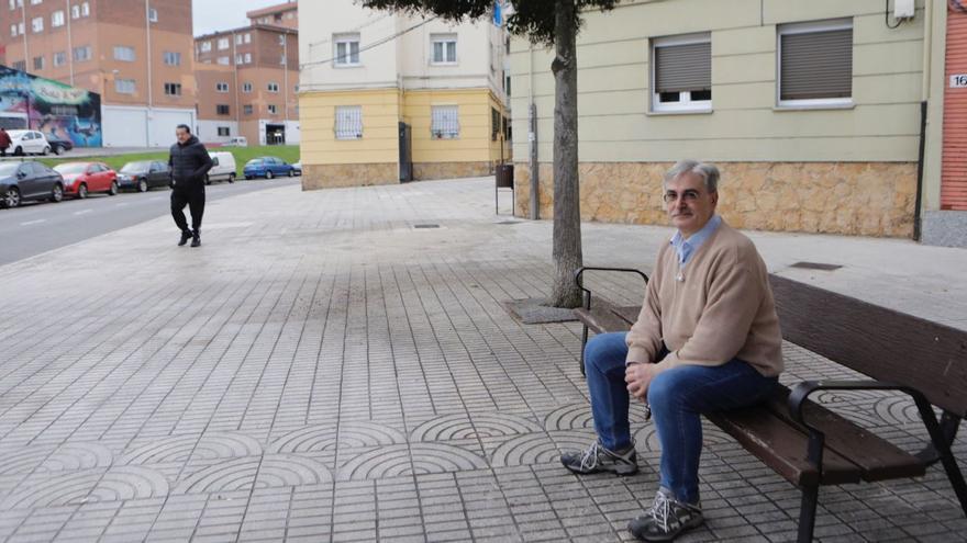 Juan Ángel Moreno, vecino del Grupo José Antonio de Pumarín, escucha música sentado en un banco del barrio. | Fernando Rodríguez