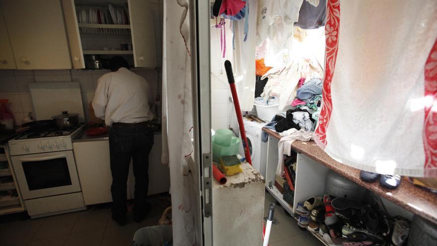 Un hombre cocina en su vivienda.