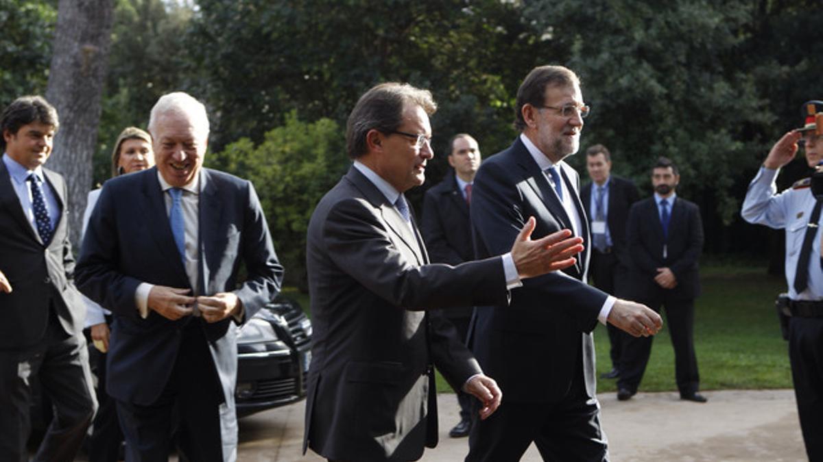 Artur Mas recibe a Mariano Rajoy. Tras ellos, el ministro García-Margallo y Jorge Moragas, hoy en el palacio de Pedralbes.