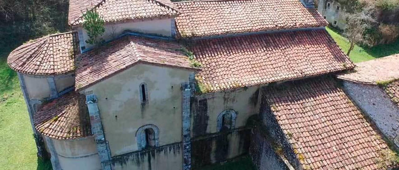 La fachada norte del templo llanisco, tomada por las humedades y con un pino en la techumbre.