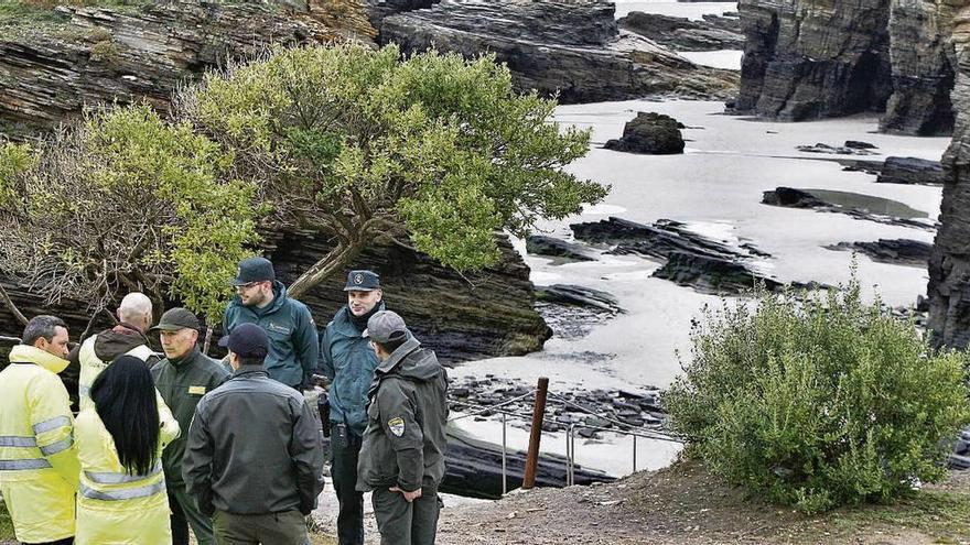 Ténicos y agentes de la Guardia Civil en la playa de As Catedrais en Ribadeo.