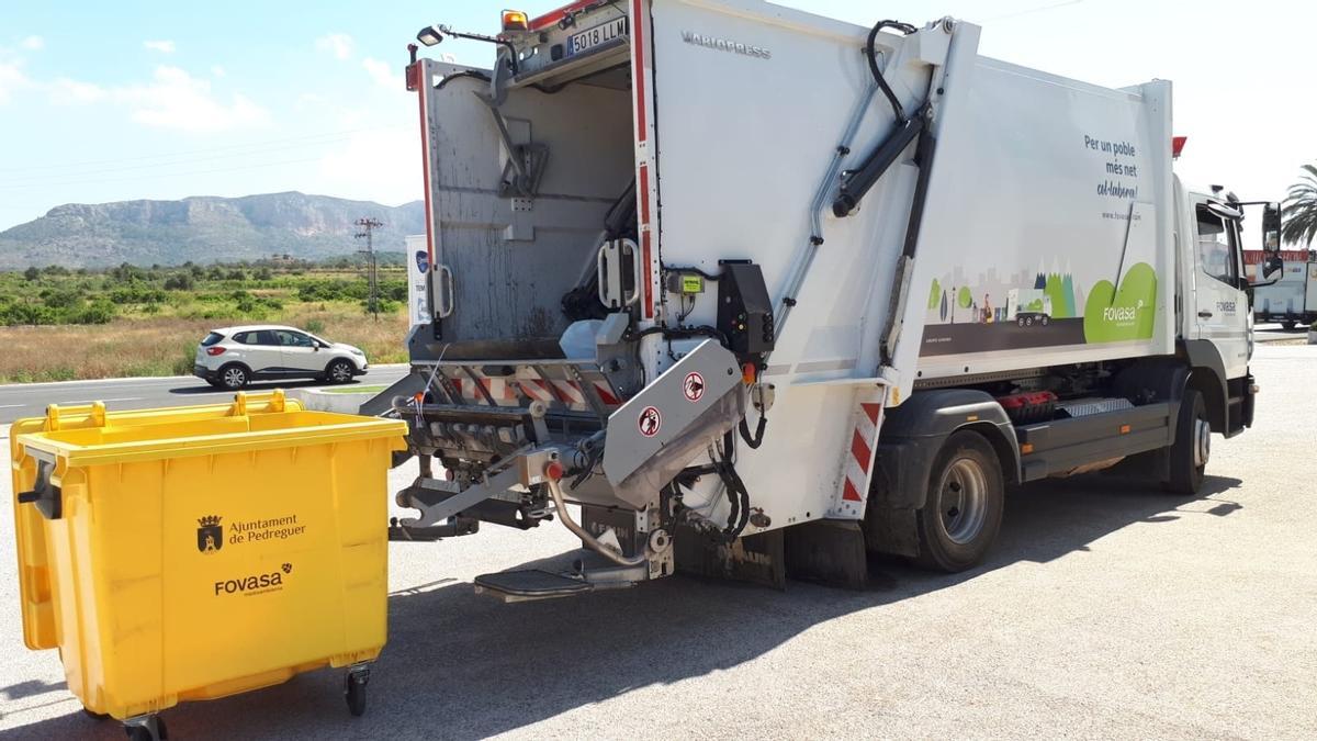 Uno de los camiones de Fovasa recoge los residuos depositados en contenedores en la localidad alicantina de Pedreguer.