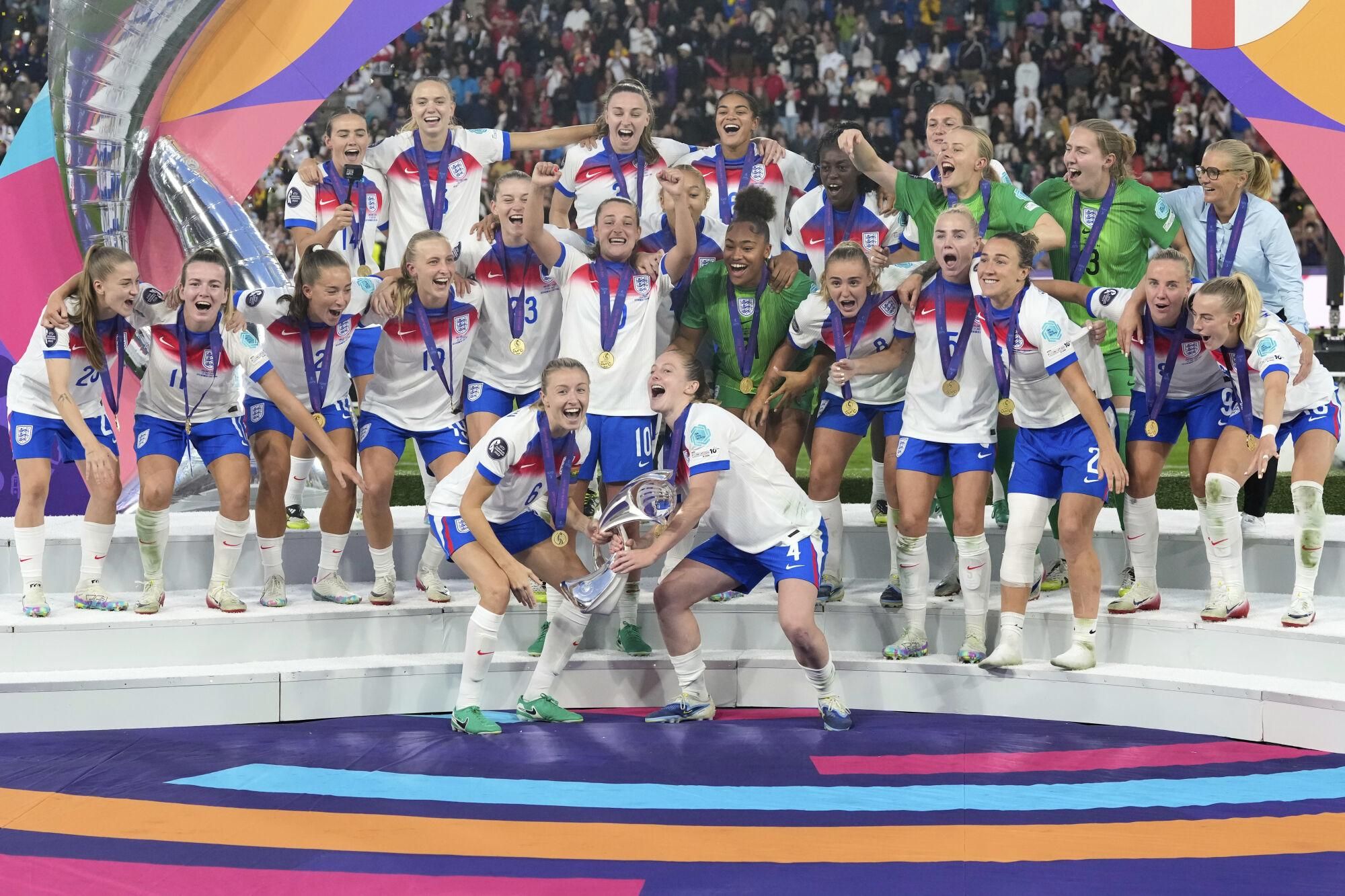 England's Leah Williamson, center left, and Keira Walsh lift the trophy after winning the Women's Euro 2025 final soccer match between England and Spain at St. Jakob-Park in Basel, Switzerland, Sunday, July 27, 2025. (AP Photo/Alessandra Tarantino)