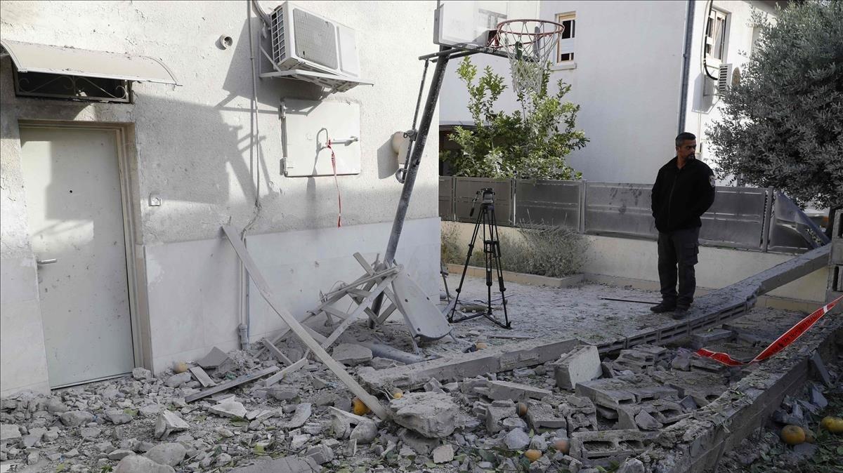 zentauroepp48020309 a man stands among debris in the yard of a  building that wa190505205701